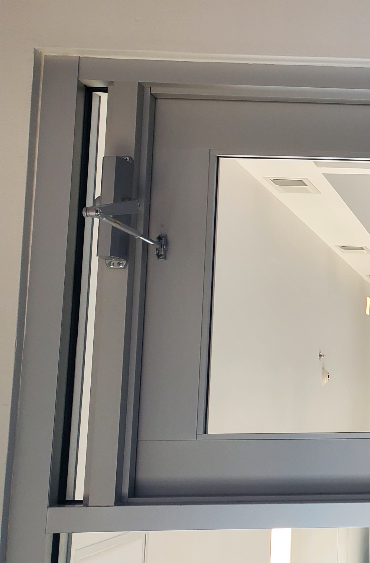 Aluminum Door Showing Glazing and Closer Installation